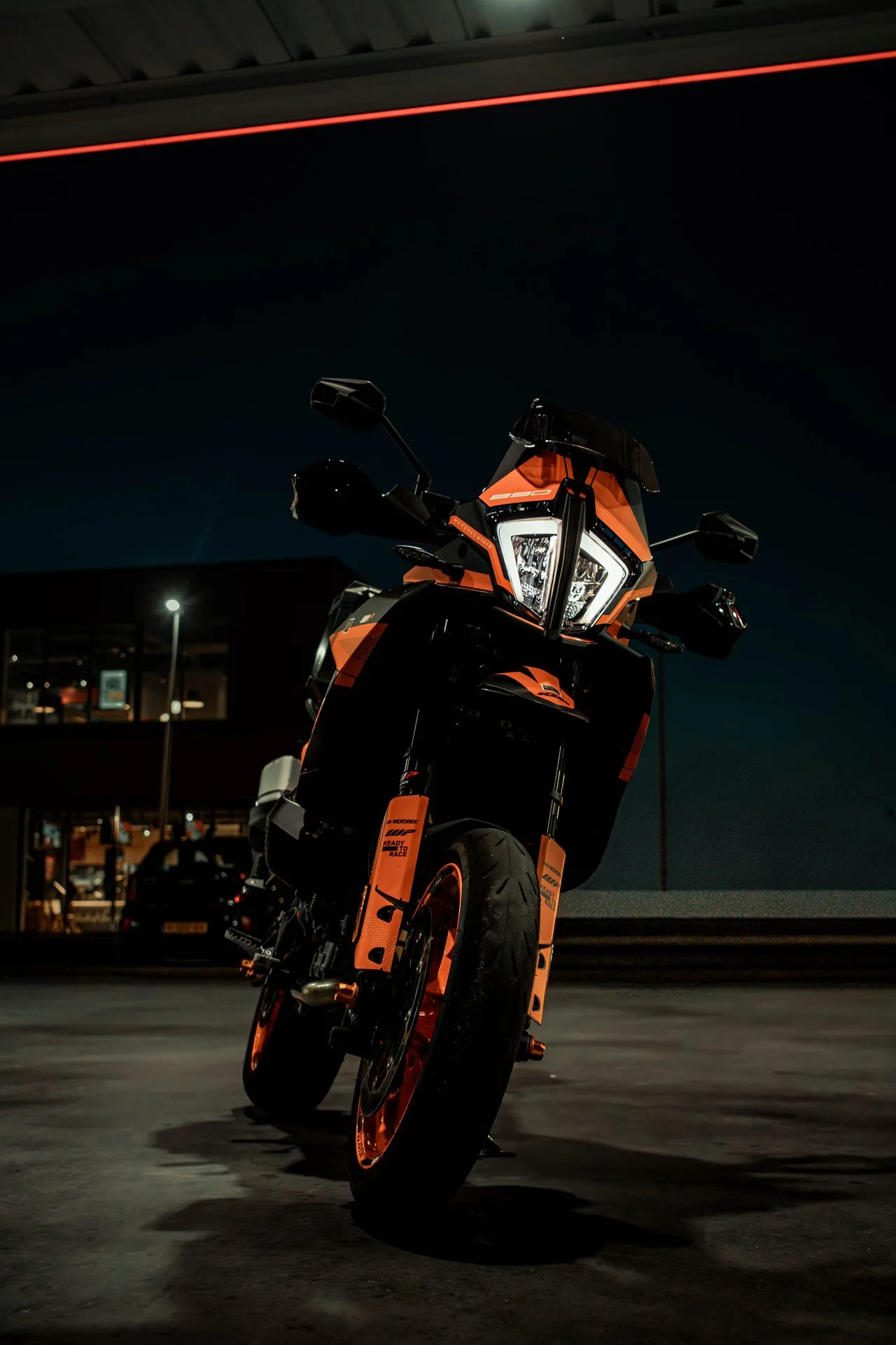 Orange KTM lit against the dark
